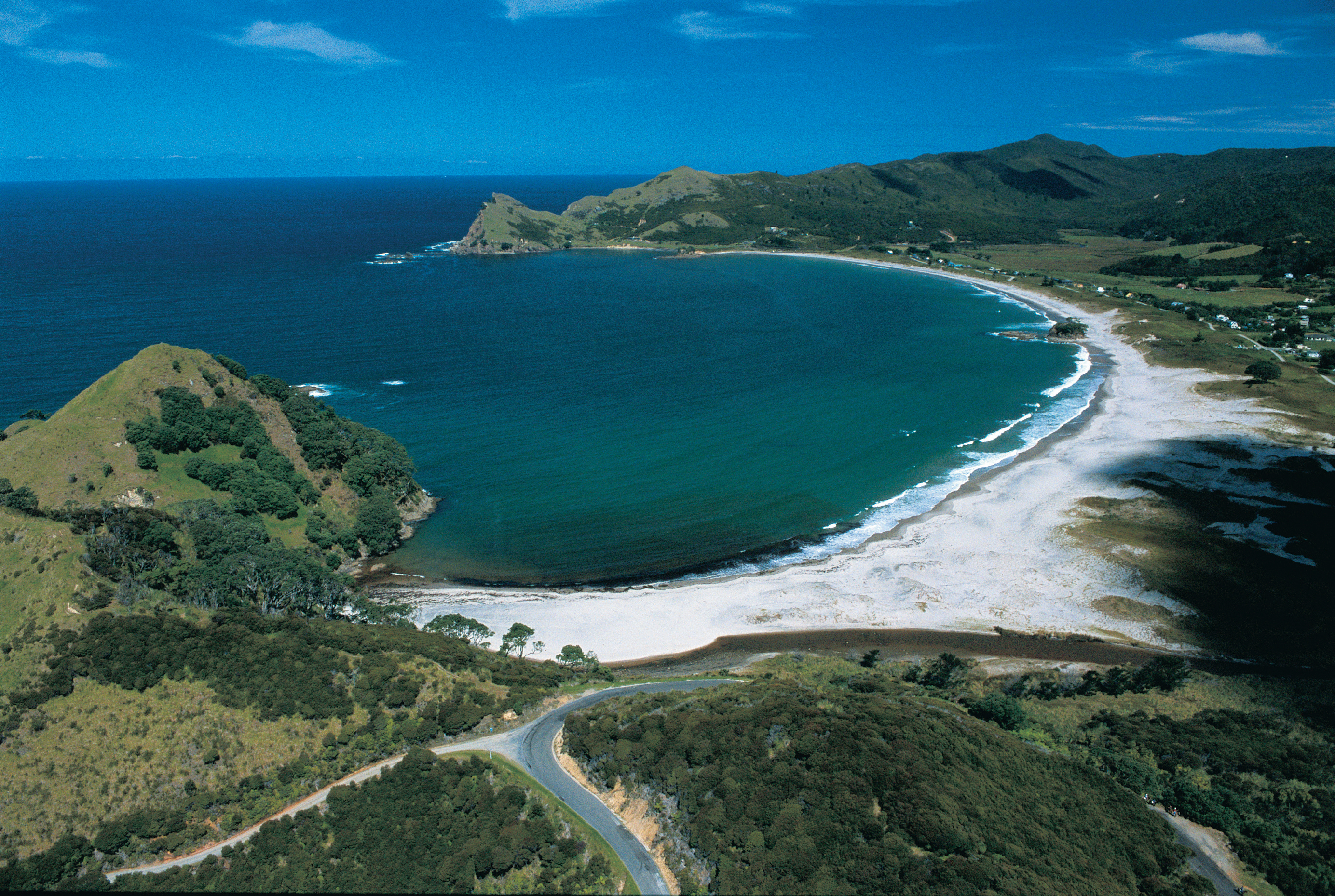 Aerial photo of the length of Medlands Beach and Oruawharo Bay, Great Barrier Island.
